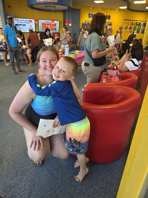 Mother hugging child during CommunityMed’s Easter event at Aqua-Tots in North Richland Hills