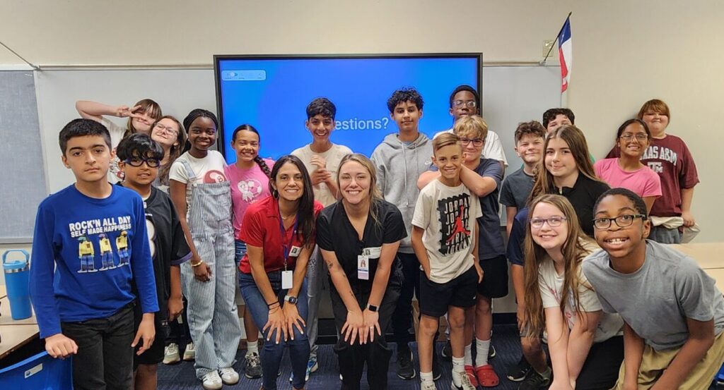 CommunityMed staff and Shady Brook Elementary students posing for a group photo after Career Day presentation in Hurst, TX
